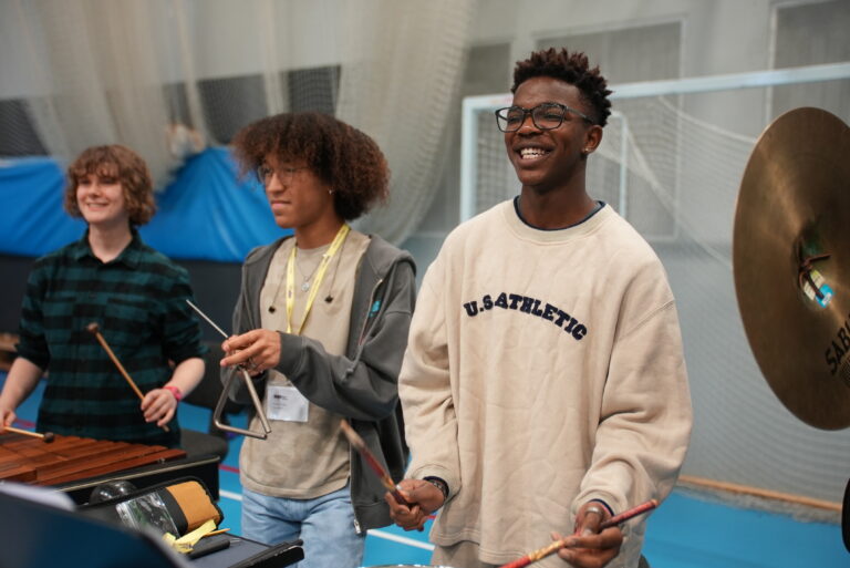 Three teenage musicians play percussion at NYO Unite.